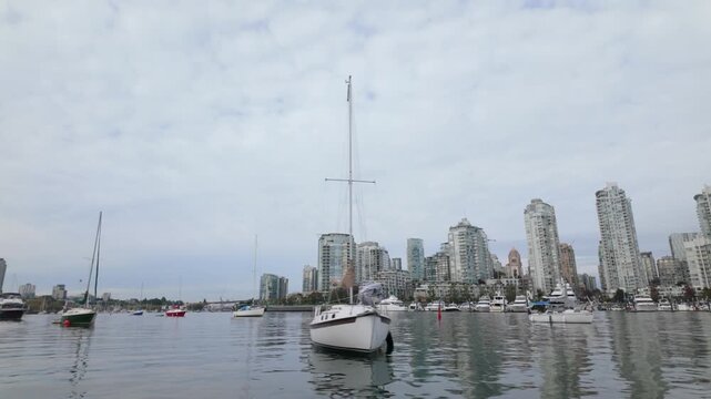 Gimbal shot of boats on False Creek as seen from a moving ferry in Vancouver, British Columbia, Canada. 4K