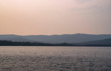 Colors in hazy sky over lake in Alaska