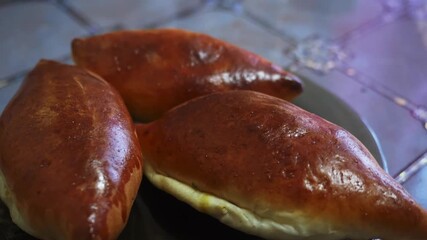 Golden-brown pastries are artfully arranged on a plate, showcasing their flaky texture. A delicious and inviting close-up of freshly baked goods.