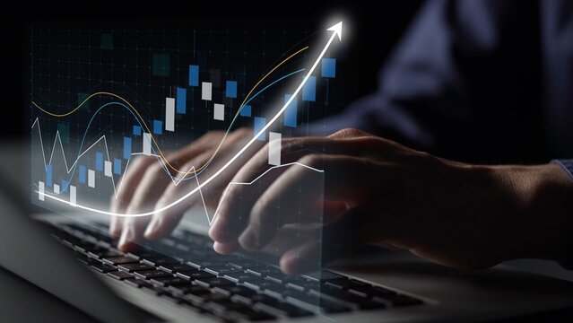 A close-up image capturing hands typing on a laptop with vibrant data charts and graphs symbolizing growth and analytics in a dark, professional environment. Copula - Powered by Adobe
