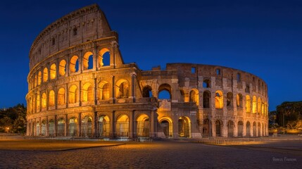 Illuminated Ancient Roman Colosseum at Night with Warm Lighting and Clear Sky