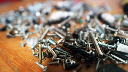 Close-up of silver metal nuts and bolts in industrial workshop