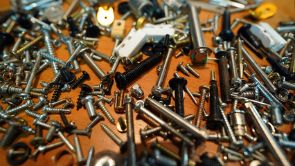 Close-up of silver metal nuts and bolts in industrial workshop