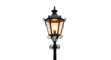 Classic black ornate street lamp with glowing warm light bulb isolated on transparent background