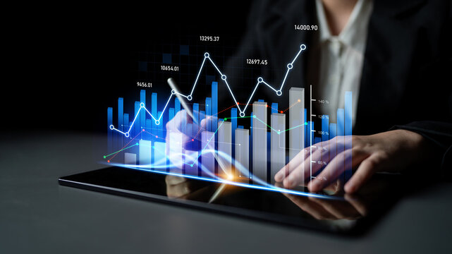 A business professional uses a digital tablet to analyze financial data, featuring graphical charts and data visualization in a sleek office environment. Scalp - Powered by Adobe