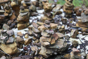 Many peaceful cairn stone stacks in nature creating spiritual arrangement. zen concept of balance, harmony, and meditation representing stability and tranquility outdoors