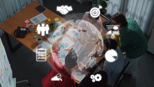 A diverse business team collaborates in a modern office environment, analyzing global data with charts and icons to strategize for growth and success. Raster - Powered by Adobe