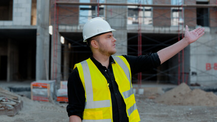 A construction worker is inspecting the building site