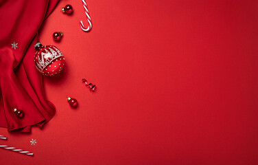 Christmas decorations with red fabric on red background with bokeh, glitter. Merry Christmas and...