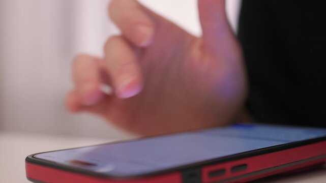 Nightly hand gestures on smartphone, Fingers tapping and engaging with phone during night hours, Closeup shot capturing hand movements interacting with mobile device at night