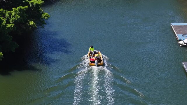 Workers Navigate Small Utility Boat Under Canal Bridge in Australia