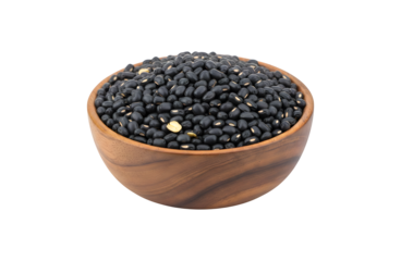 Black beans (Urad dal, black gram, vigna mungo bean) sitting in a wooden bowl, isolated against a white background

