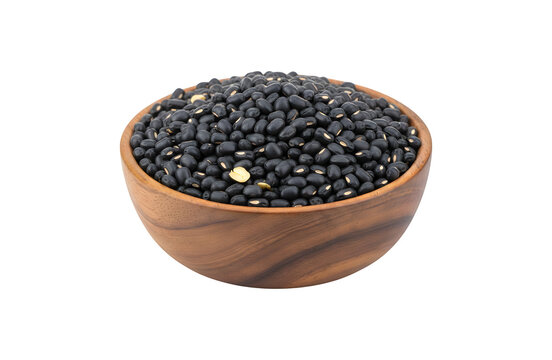 Black beans (Urad dal, black gram, vigna mungo bean) sitting in a wooden bowl, isolated against a white background


