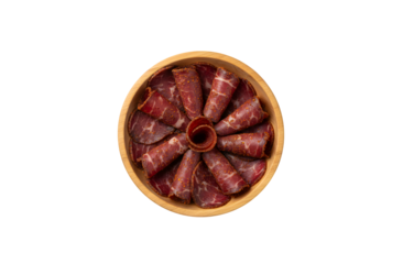 Armenian Basturma, a type of dried meat, displayed in a wooden bowl against a white background. Top view, flat lay.

