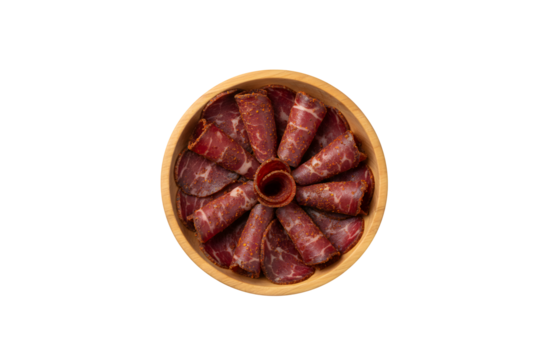 Armenian Basturma, a type of dried meat, displayed in a wooden bowl against a white background. Top view, flat lay.


