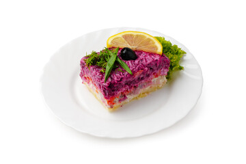 Colorful layered salad with beets, fish, and lemon served on a white plate