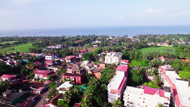 Aerial view of coastal village Colva with beach and and sky. day time, orbit shot, drone shot, 4k.