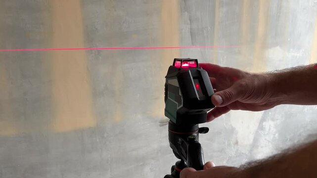 Construction finishing work in an apartment, measuring with a wireless laser level close up