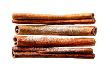Close up of several dried cinnamon sticks arranged horizontally.