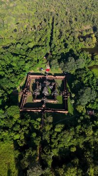 Aerial orbit left revealing the full layout of Banteay Samre Temple surrounded by dense forest in Siem Reap