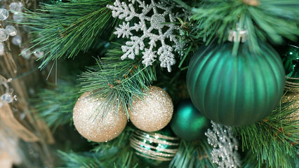 Vibrant green ornaments and ribbons decorating holiday Christmas tree
