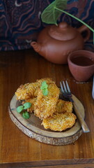 Pisang goreng served on wooden table. Made from fried banana. Selective focus