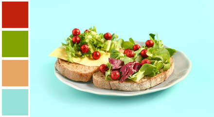 Plate of sandwiches with fresh herbs, cheese and Christmas balls on color background