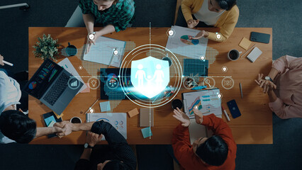 A diverse group of professionals collaborates in a modern office setting, engaging in data analysis and brainstorming while surrounded by digital interface elements. Trope