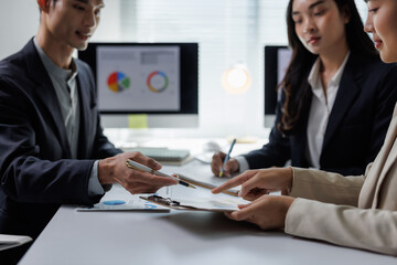 Business people reviewing financial report discussing data analysis