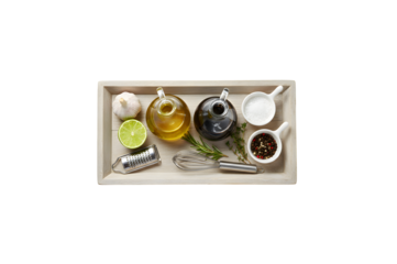 The perfect vinaigrette needs these ingredients: olive oil, balsamic vinegar, salt, pepper, garlic, and lime, all beautifully arranged on a wooden tray against a white background.
