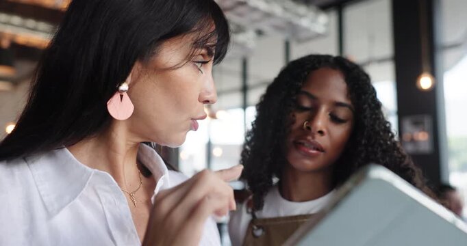 Manager, restaurant and team with tablet for planning, inventory or training. Waitress, women and technology in small business for menu discussion, scroll and coaching with owner for stock order
