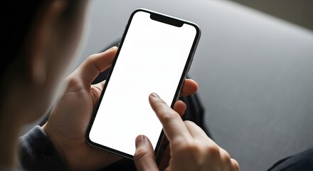 Close up of a person s hands holding and touching a modern smartphone with a blank white screen