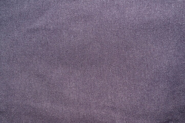 Close-up of a textured dark purple fabric background