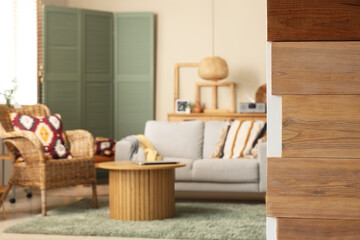 Interior of light living room with cozy sofa and coffee table