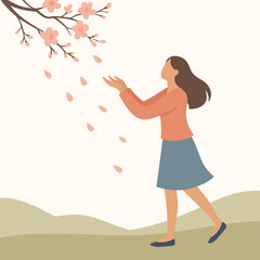 Girl walking under falling blossoms