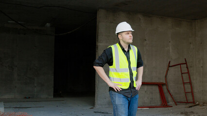 A construction worker is inspecting the building site
