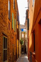 View of colourful Collioure, narrow streets and yellow, pink, orange houses, summer vacation destination town with historical buidings and beaches, Pyrenees-Orientales, France