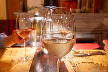 Drinking of white wine in restaurant for dinner, glasses of white wine in Italy, France, European lifestyle