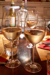 Drinking of white wine in restaurant for dinner, glasses of white wine in Italy, France, European lifestyle