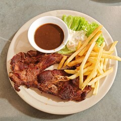 Grilled Steak with Fries, black pepper sauce and salad
