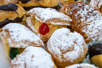 Italian sweet dessert dolce pastry and cakes with cream and fruits on plate made in artisanal bakery in Rome, Italy, close up