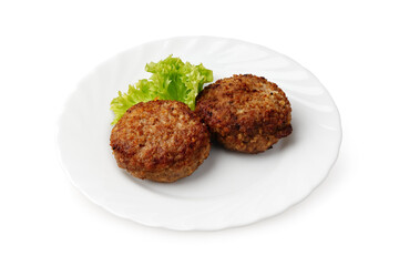 Crispy meat patties served on a white plate with fresh lettuce garnish