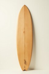 A Classic Wooden Surfboard Leaning Against a Neutral Background, Displaying its Smooth, Light-Colored Wood Grain and Simple Design