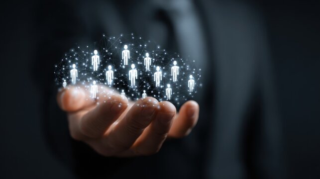 Human Cloud: A businessman's hand cradles a constellation of illuminated human silhouettes, symbolizing connections and digital presence.