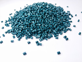 plastic masterbatch, green masterbatch granules as virgin polymer resin pigment, poured into white background media, suitable for industrial plastic company profile product catalog design, top view