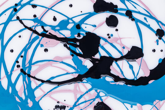 Beautiful acrylic paint pattern in three colors. Smooth lines of circles in a chaotic order. different drops of paint. Abstract modern art background.