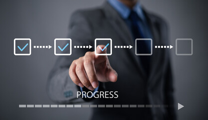 Businessman using check mark on checklist with progressive loading status to remind work in progress for project development management and idea tracking.