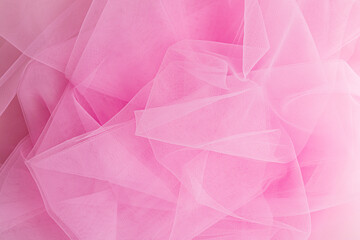 Luxurious design of a wedding veil in a delicate pink color. soft folds of a transparent veil. top view. layout for design. wallpaper. A copy space.