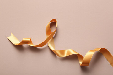 Beautiful golden ribbon on color background