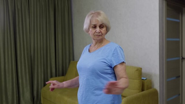Mature woman performing targeted upper body strength training and mobility exercises indoors, demonstrating healthy aging through consistent physical activity and engagement